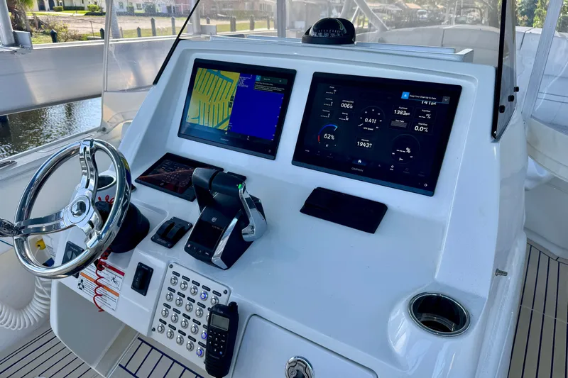  Yacht Photos Pics Intrepid 327 Cuddy 2025 boat dashboard with navigation screens and controls.
