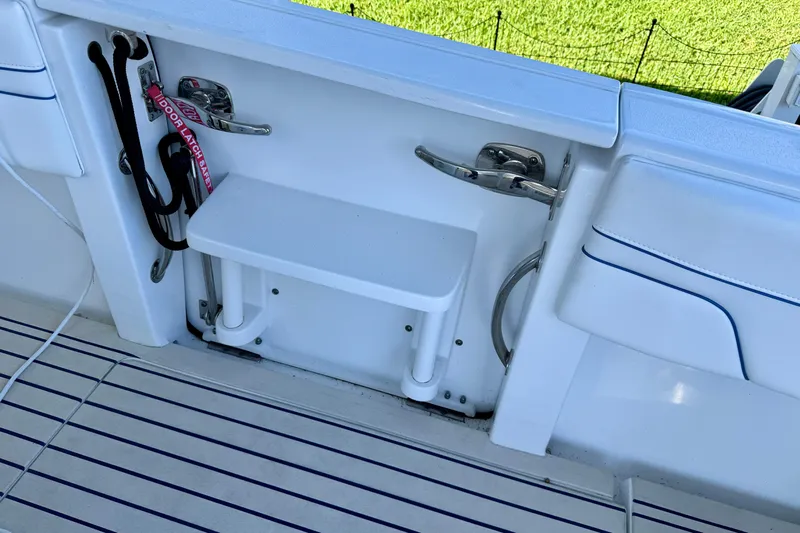  Yacht Photos Pics 2025 Intrepid 327 Cuddy boat deck with step and safety latch.