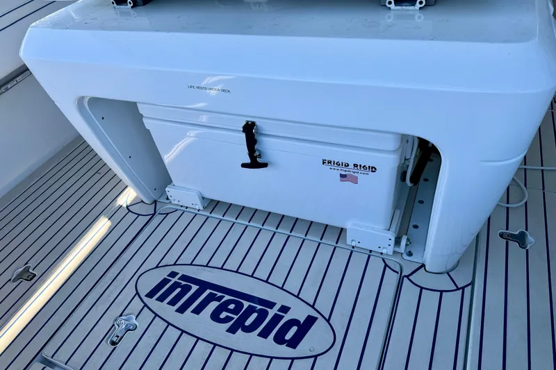  Yacht Photos Pics 2025 Intrepid 327 Cuddy boat deck with Frigid Rigid cooler and branded flooring.