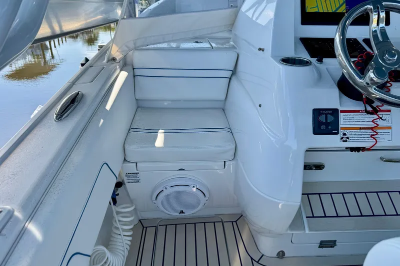  Yacht Photos Pics 2025 Intrepid 327 Cuddy boat interior with seating and steering wheel.