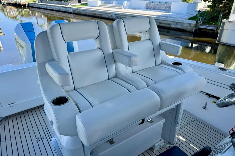  Yacht Photos Pics Luxury seating on 2025 Intrepid 327 Cuddy boat, featuring comfortable armrests and cup holders.