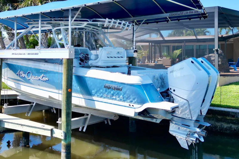  Yacht Photos Pics 2025 Intrepid 327 Cuddy boat with dual Mercury engines on a lift.