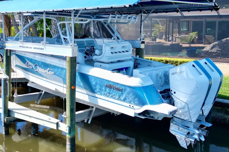  Yacht Photos Pics 2025 Intrepid 327 Cuddy boat with dual Mercury engines on a lift.