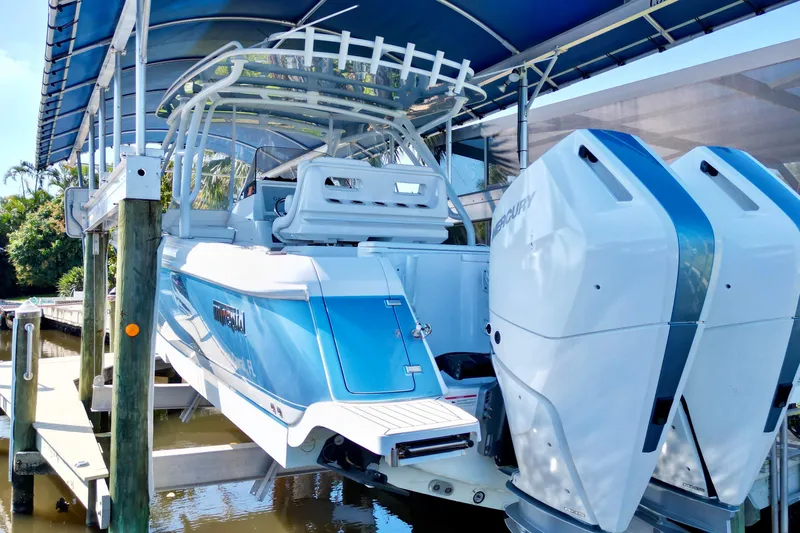  Yacht Photos Pics 2025 Intrepid 327 Cuddy boat with dual Mercury engines on a lift.