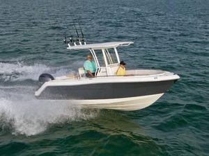 2015 Robalo R222 boat cruising on open water with two passengers.