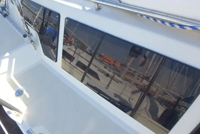 Si J'avais Su Yacht Photos Pics Custom Gilbert Caroff Lex Eterna 47 yacht, 2017, with reflective windows and marina view.