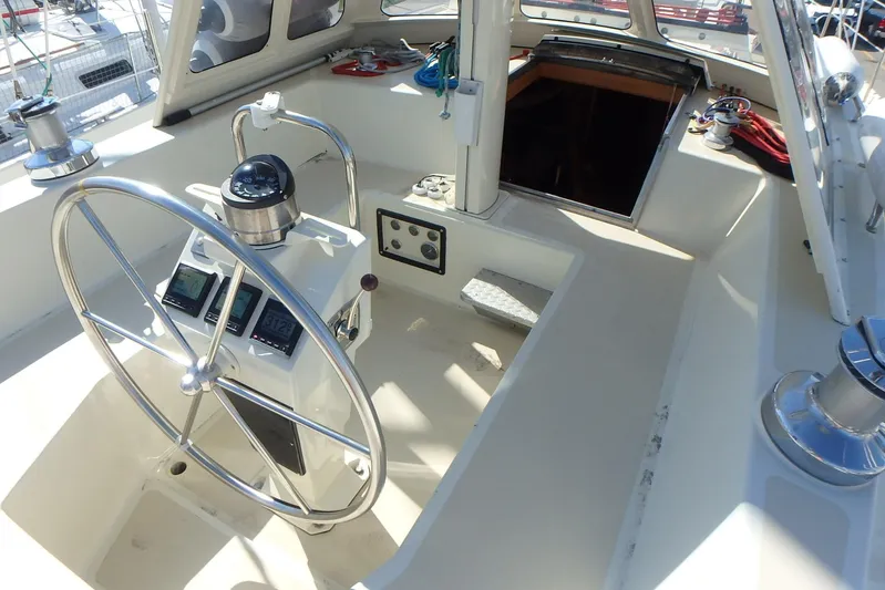 Si J'avais Su Yacht Photos Pics Cockpit of 2017 Custom Gilbert Caroff Lex Eterna 47 sailboat with steering wheel and navigation instruments.