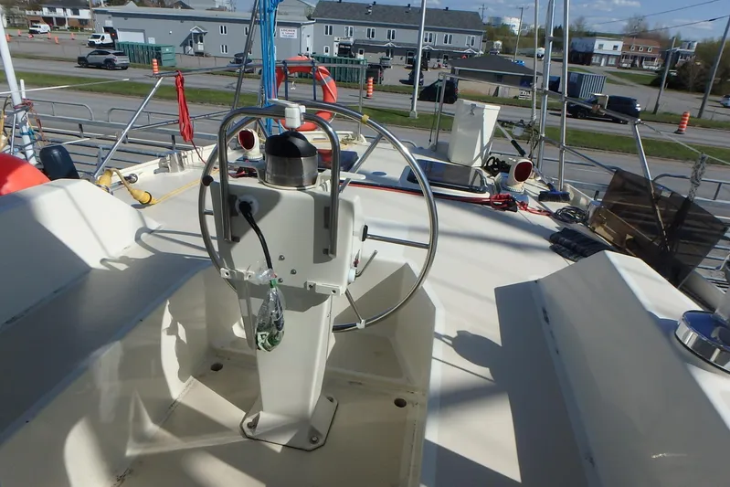 Si J'avais Su Yacht Photos Pics Steering wheel of 2017 Custom Gilbert Caroff Lex Eterna 47 sailboat, docked in a marina.