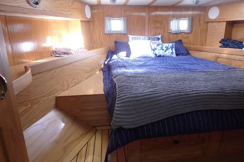 Si J'avais Su Yacht Photos Pics Cozy cabin interior of 2017 Custom Gilbert Caroff Lex Eterna 47 with wooden finish and bed.