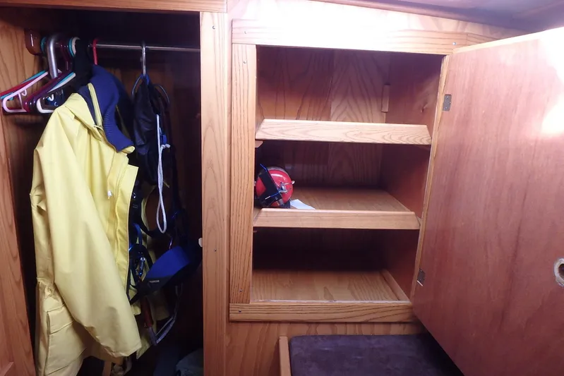 Si J'avais Su Yacht Photos Pics Wooden closet with yellow jacket and empty shelves on a 2017 Gilbert Caroff Lex Eterna 47.