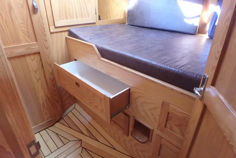 Si J'avais Su Yacht Photos Pics Wooden interior of 2017 Gilbert Caroff Lex Eterna 47 with bed and open drawer.