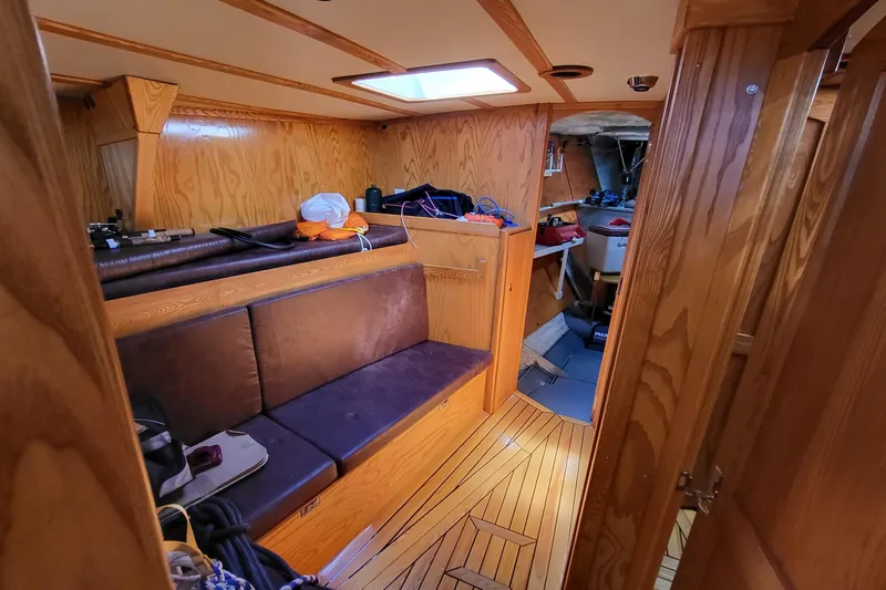 Si J'avais Su Yacht Photos Pics Interior of 2017 Custom Gilbert Caroff Lex Eterna 47 sailboat with wooden finish and seating area.