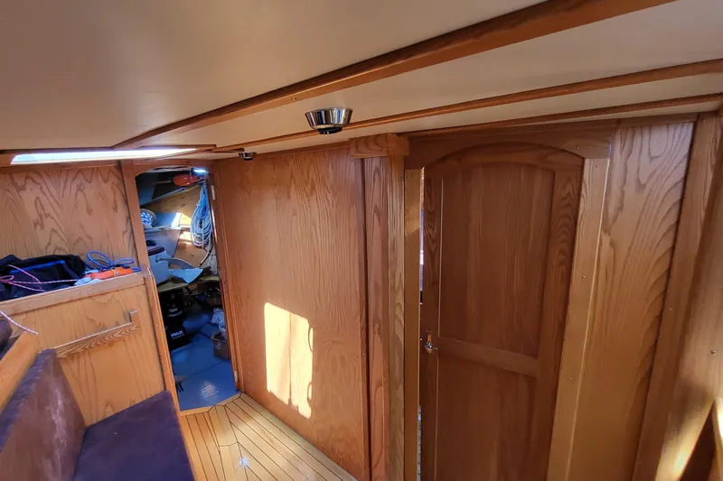 Si J'avais Su Yacht Photos Pics Interior of 2017 Custom Gilbert Caroff Lex Eterna 47 with wooden paneling and cozy cabin space.