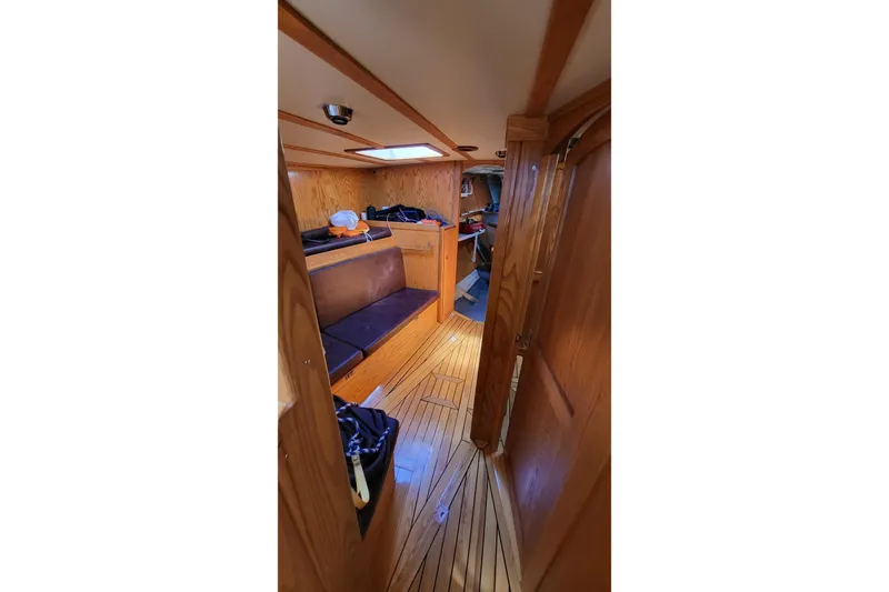 Si J'avais Su Yacht Photos Pics Interior of 2017 Gilbert Caroff Lex Eterna 47 sailboat with wooden finishes and seating area.