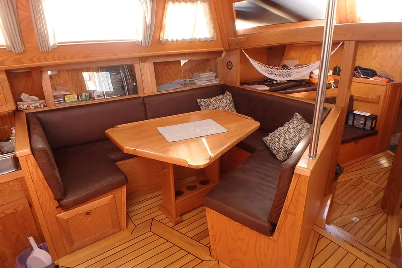 Si J'avais Su Yacht Photos Pics Cozy interior of 2017 Custom Gilbert Caroff Lex Eterna 47 sailboat with wooden furnishings.