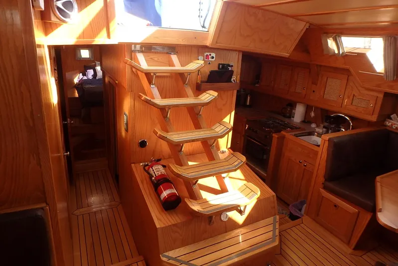 Si J'avais Su Yacht Photos Pics Interior of 2017 Gilbert Caroff Lex Eterna 47 yacht with wooden finish and staircase.