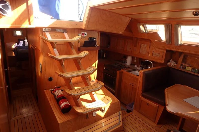 Si J'avais Su Yacht Photos Pics Interior of 2017 Custom Gilbert Caroff Lex Eterna 47 yacht with wooden finish and compact kitchen.