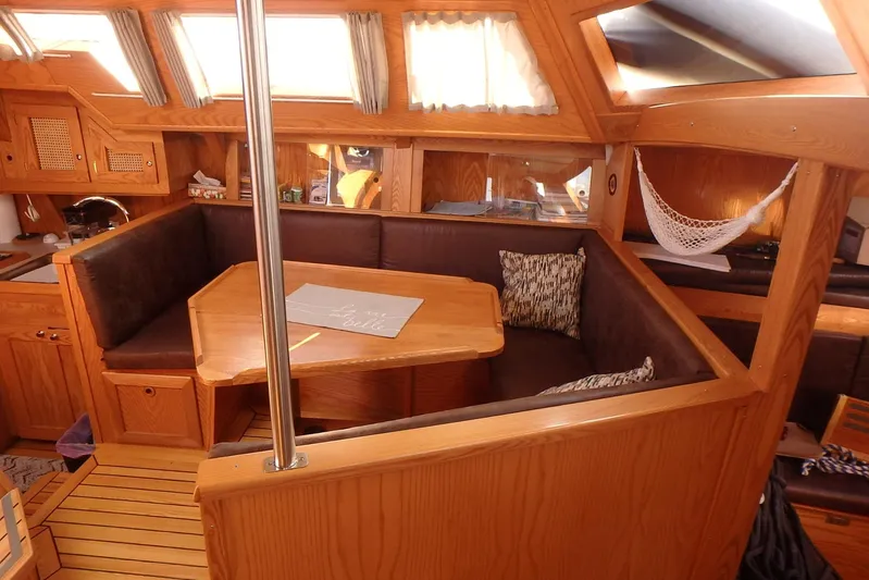 Si J'avais Su Yacht Photos Pics Cozy interior of 2017 Custom Gilbert Caroff Lex Eterna 47 sailboat with wooden furnishings.