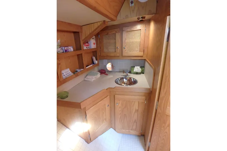 Si J'avais Su Yacht Photos Pics Wooden interior of 2017 Custom Gilbert Caroff Lex Eterna 47 with sink and storage cabinets.