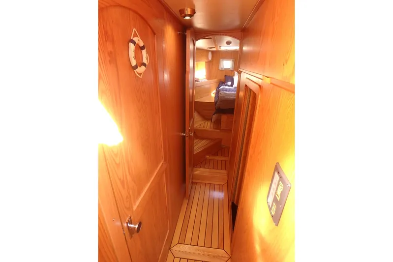 Si J'avais Su Yacht Photos Pics Wood-paneled interior of 2017 Custom Gilbert Caroff Lex Eterna 47 yacht, featuring cozy cabin space.