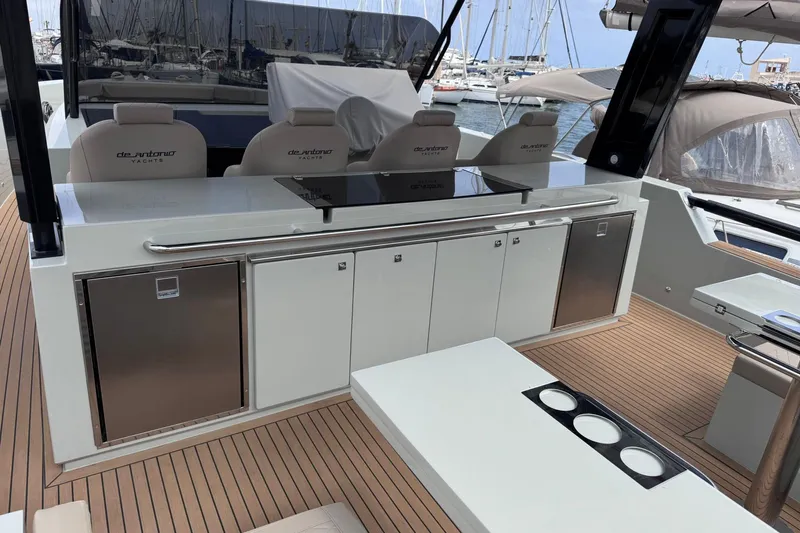  Yacht Photos Pics 2024 De Antonio Yachts D50 deck with sleek kitchen and seating area.