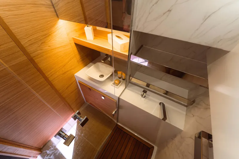  Yacht Photos Pics Luxurious bathroom interior of 2024 De Antonio Yachts D50, featuring modern sink and wooden accents.