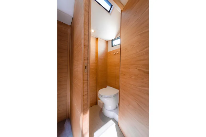  Yacht Photos Pics 2024 De Antonio Yachts D50 bathroom with wood paneling and modern design.