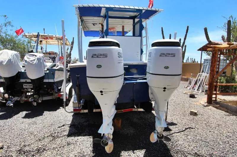  Yacht Photos Pics 2022 Grady-White Canyon 336 boat with dual Suzuki 225 outboard engines, parked on gravel.