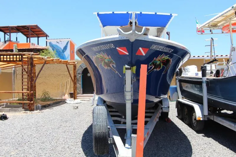  Yacht Photos Pics 2022 Grady-White Canyon 336 boat on trailer, vibrant graphics, sunny day, outdoor setting.