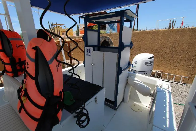  Yacht Photos Pics 2022 Grady-White Canyon 336 boat interior with life jackets and Suzuki engine.