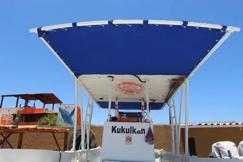  Yacht Photos Pics 2022 Grady-White Canyon 336 boat with blue canopy, named Kukulkan, under clear sky.