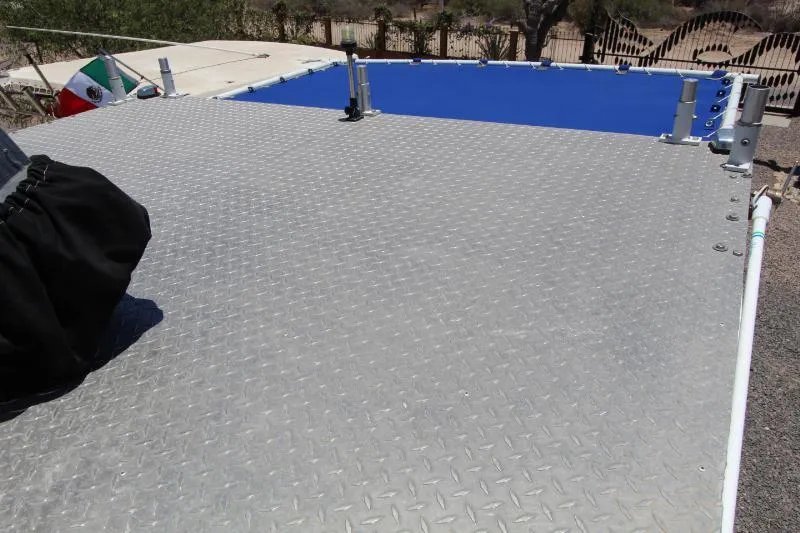  Yacht Photos Pics Aluminum deck of 2022 Grady-White Canyon 336 boat with blue cover and Mexican flag.