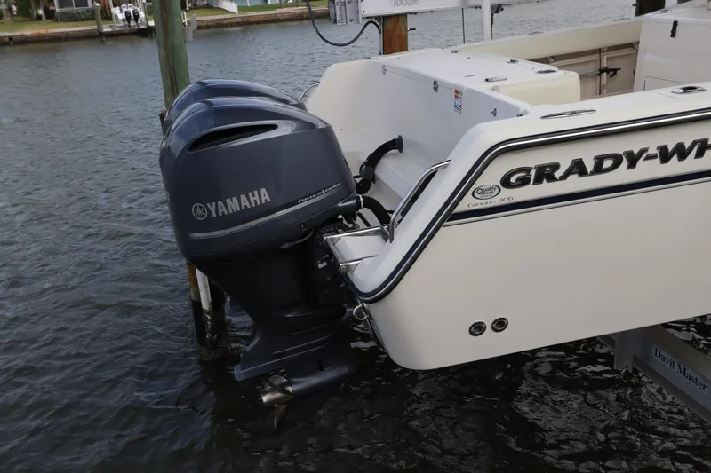  Yacht Photos Pics 2015 Grady-White Canyon 306 boat with Yamaha outboard motors docked in water.