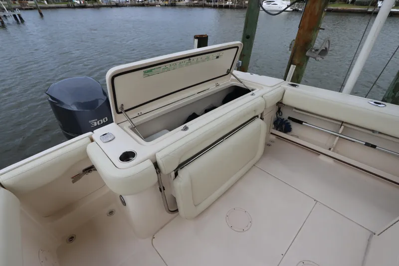  Yacht Photos Pics 2015 Grady-White Canyon 306 boat deck with open storage compartment and outboard motor.