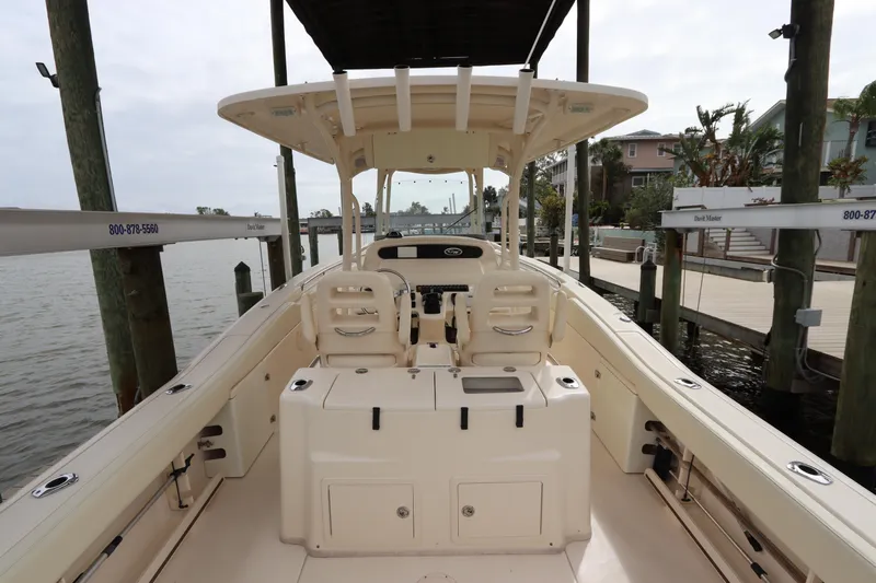  Yacht Photos Pics 2015 Grady-White Canyon 306 boat interior at dock, showcasing seating and helm.