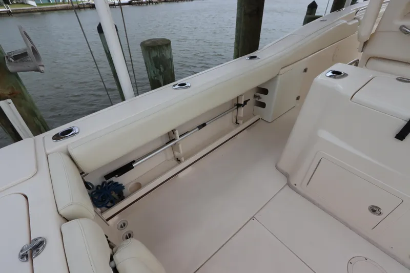  Yacht Photos Pics 2015 Grady-White Canyon 306 boat interior with seating and storage near dock.