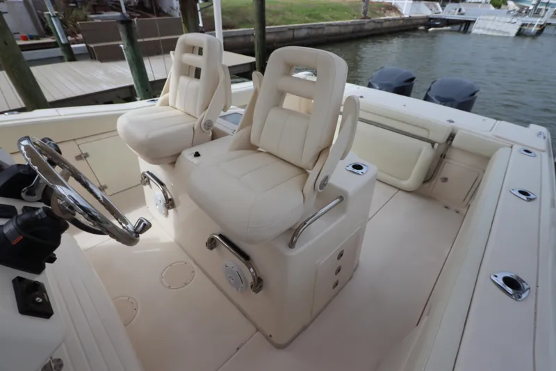  Yacht Photos Pics 2015 Grady-White Canyon 306 boat interior with dual captain's chairs and steering wheel.