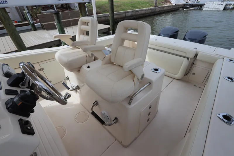  Yacht Photos Pics 2015 Grady-White Canyon 306 boat interior with dual captain's chairs and steering wheel.