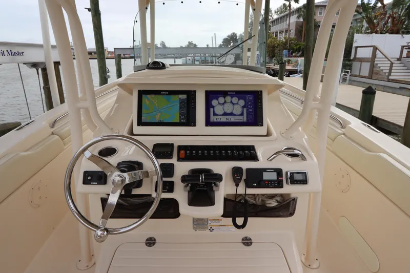  Yacht Photos Pics 2015 Grady-White Canyon 306 boat dashboard with navigation screens and steering wheel.