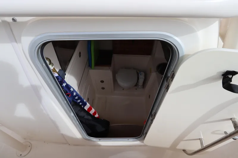  Yacht Photos Pics Interior view of 2015 Grady-White Canyon 306 boat cabin with toilet and American flag.