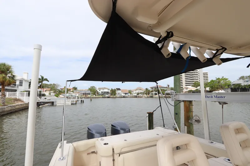  Yacht Photos Pics 2015 Grady-White Canyon 306 boat docked with sunshade, scenic waterfront view.