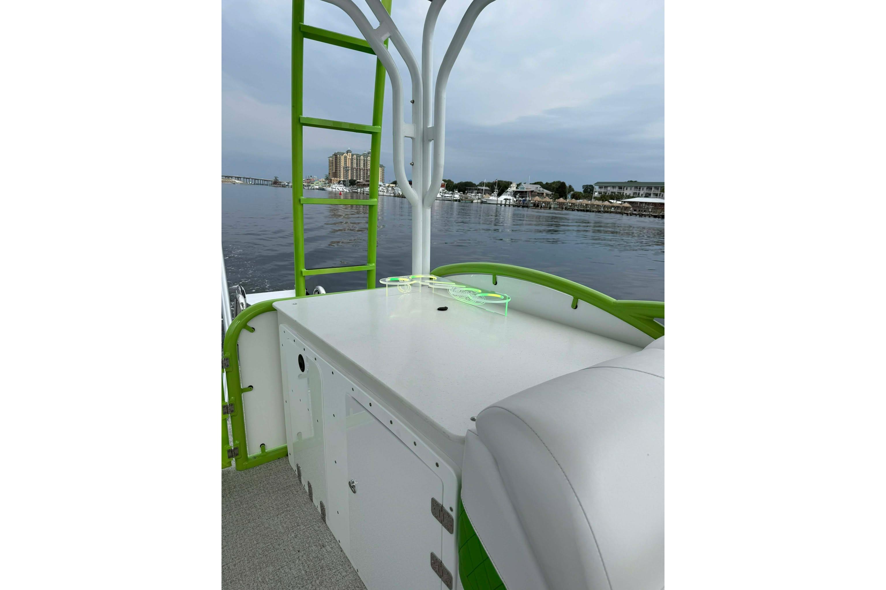 Aloha Pontoon 300, 2026 model, on calm waters with green accents and seating.