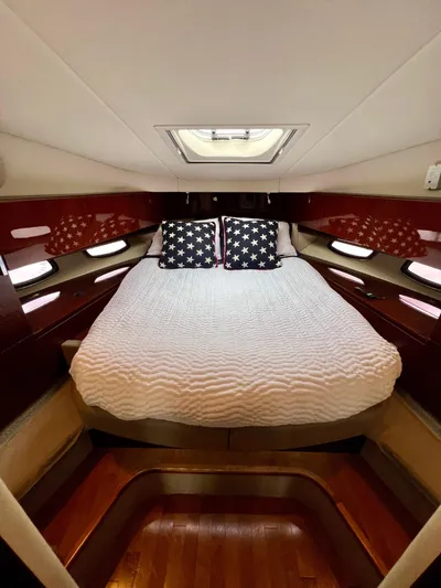 Equinox Yacht Photos Pics Luxurious bedroom in 2010 Sea Ray 470 Sundancer yacht with skylight and star-themed pillows.
