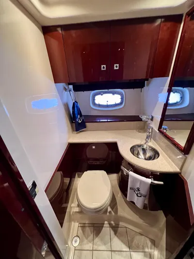 Equinox Yacht Photos Pics 2010 Sea Ray 470 Sundancer bathroom with modern fixtures and wood cabinetry.