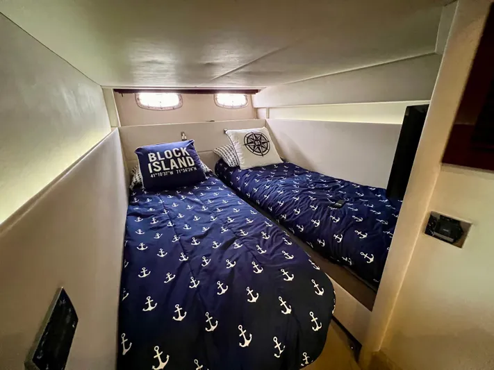 Equinox Yacht Photos Pics 2010 Sea Ray 470 Sundancer cabin with twin beds and nautical-themed bedding.