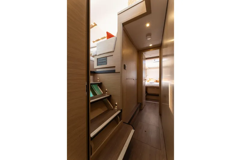 Aura Yacht Photos Pics 2024 Lagoon 46 yacht interior hallway with wooden stairs and cozy cabin view.