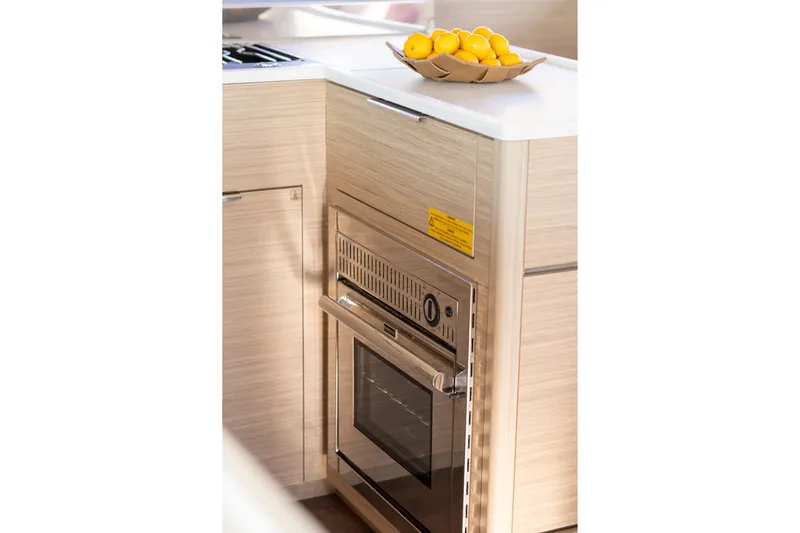 Aura Yacht Photos Pics Modern kitchen in 2024 Lagoon 46 yacht with oven and lemons on counter.