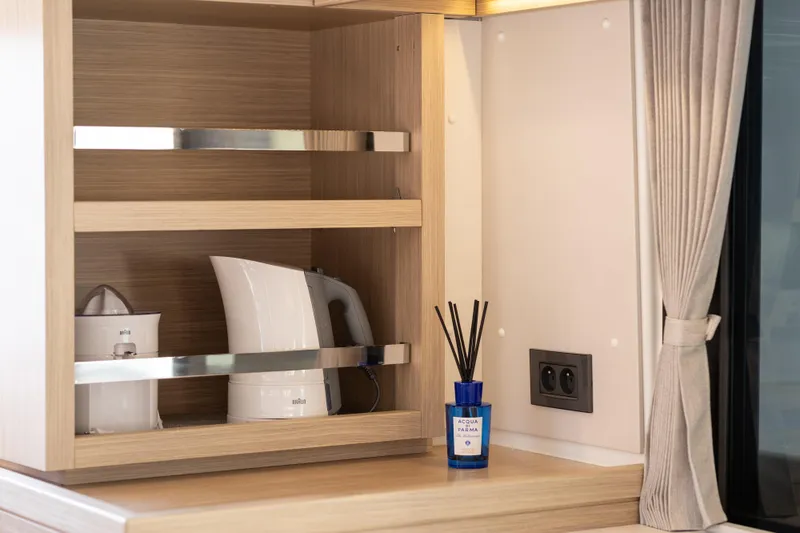 Aura Yacht Photos Pics Modern kitchen shelf in 2024 Lagoon 46 yacht with kettle and diffuser.