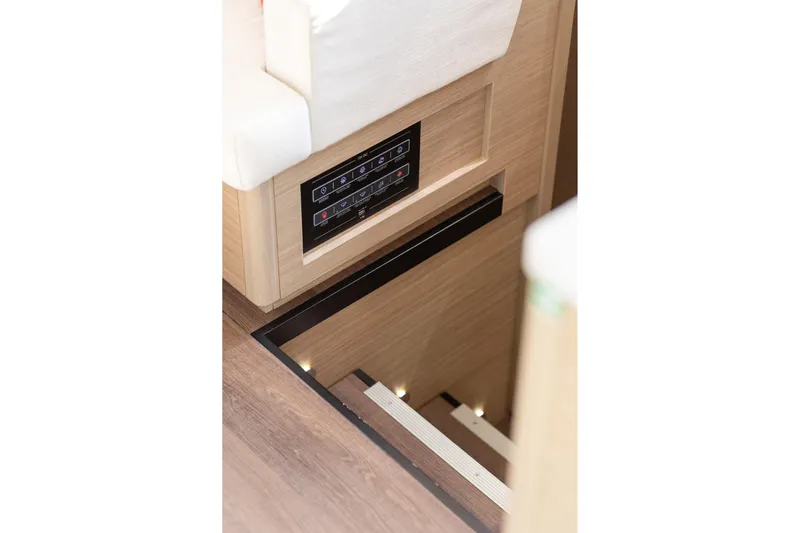 Aura Yacht Photos Pics 2024 Lagoon 46 yacht interior with control panel and wooden staircase.