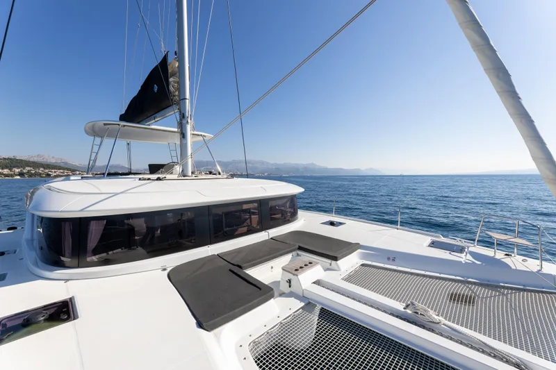 Aura Yacht Photos Pics 2024 Lagoon 46 catamaran on open sea, featuring spacious deck and modern design.